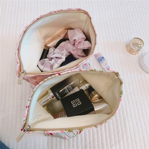 Top view of large capacity floral jacquard fabric cosmetic bags with silver zippers