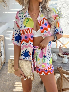 Detail of colorful bohemian print shorts set featuring abstract wave and star patterns