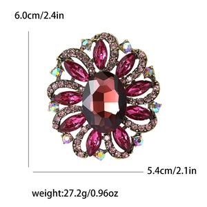 Detail view of flower brooch with red crystal and size dimensions 6.0cm by 5.4cm