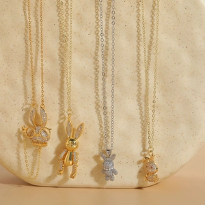Detailed view of four rabbit-shaped pendants featuring 14K gold plating and cubic zirconia