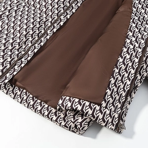 Detail of geometric print fabric, smooth silk lining and premium metal zipper on jacket