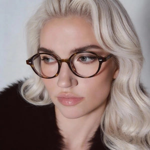 Stylish tortoise shell oval glasses frame for women shown on model for vintage nerd look