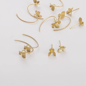 Sparkling butterfly earrings set with 14K gold plated copper hooks and studs on white background