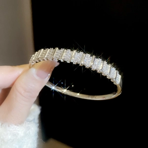 Close-up of 18k gold plated bangle with pavé-set cubic zirconia in geometric pattern