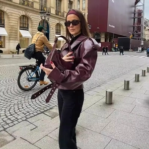 Retro burgundy leather jacket with lapel collar and matching tote bag in urban setting