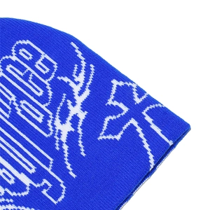 Detailed knit texture of navy beanie with white gothic cross pattern and fine stitching