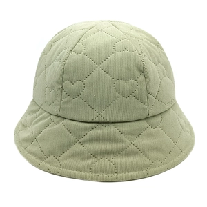 Close-up of light green corduroy bucket hat with unique heart-shaped quilted stitching details