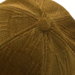 Detailed close-up of textured knit baseball cap crown featuring 3D ribbed stitch pattern