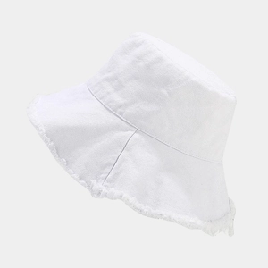 Detail of frayed edge on a white washed cotton bucket hat showing casual street style