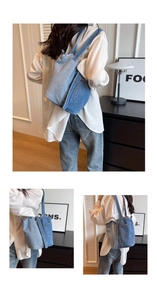 Detailed close-up of a blue patchwork denim tote bag worn on a woman's shoulder