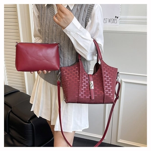 Detailed view of burgundy PU leather tote set with geometric patterns and clutch