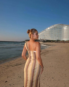 Close-up of vibrant wave pattern and slim fit one-shoulder design on a long beach dress