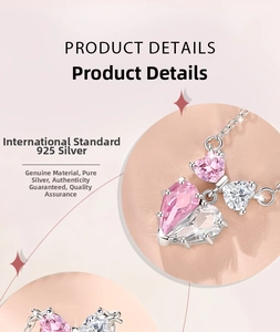 Detail of 925 silver necklace with pink heart and butterfly cubic zirconia pendant