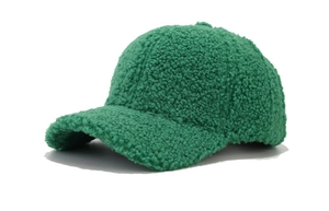 Detail of dark green fuzzy lamb wool baseball cap with thick plush texture and curved brim