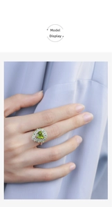 Close-up of heart-cut olive green gemstone cocktail ring with micro-pave setting