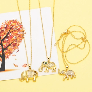Golden elephant pendant necklace with zircon crystals on a bright yellow artistic background