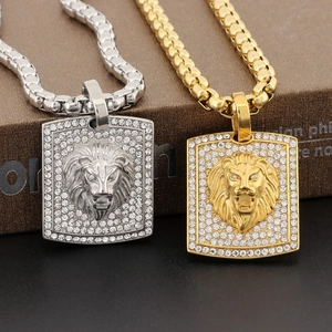 Detailed close-up of gold and silver hip hop lion head pendants with sparkling rhinestones