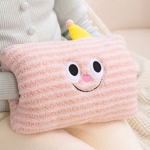 Pink plush hand warmer pillow with cute cartoon smile and striped texture for winter comfort