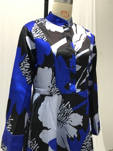 Detail of floral print satin dress featuring stand collar and button-down front