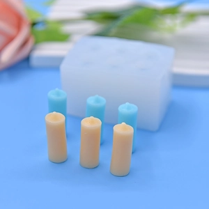 DIY silicone mold for candle making with six holes and finished cylinder wax pieces