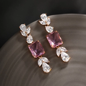 Macro detail of pink square-cut zircon earrings with pear-shaped stones in rose gold