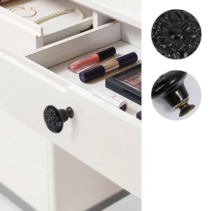 Detail of vintage black floral ceramic knob with bronze base for cabinet drawer decor