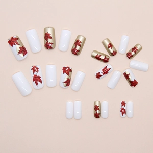 Pearly red maple leaf square press-on nails set in white and champagne gold colors