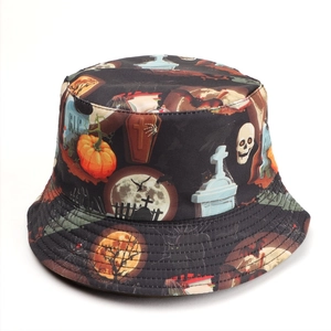 Close-up of Halloween bucket hat featuring pumpkin, skull, and RIP gravestone prints