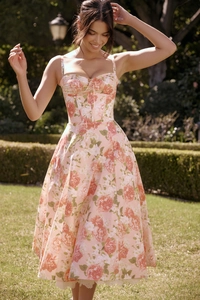 Detailed close-up of pink floral dress with corset waist and large rose prints