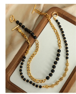 Detail of vintage gold chain and black onyx beaded necklace with elegant OT toggle clasp