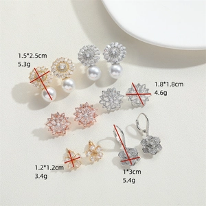 Set of vintage floral earrings featuring sunflower and snowflake designs with pearls