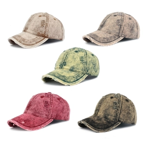 Close-up of distressed vintage denim baseball caps with frayed edges in five colors