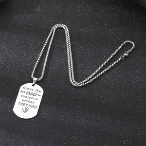 Macro detail of stainless steel dad pendant with engraved gratitude message and box chain