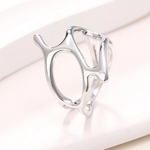 Macro view of metallic fluid ring with liquid lava texture and organic hollow design