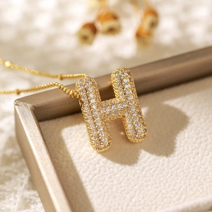 Gold balloon letter H pendant necklace with clear zircons in a premium gift box
