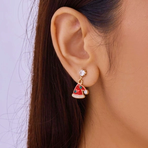 Close-up of a festive gold Christmas hat earring with red and green gemstone accents