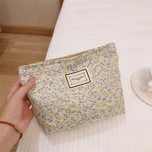 Handheld floral makeup bag with purple flower pattern and Time To Party label