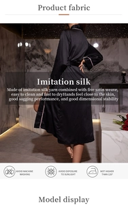 Detailed view of black satin silk bathrobe with pink trim and laundry instructions