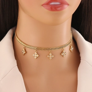 Elegant gold necklace with five clear gemstone four-leaf clover charms on a model
