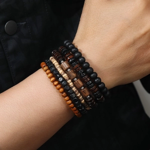 Detailed view of layered wooden beaded bracelets with vintage coconut shell accents