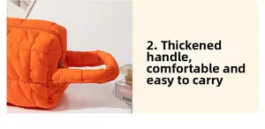 Detail of orange quilted vanity bag with thick handle and durable metal zipper