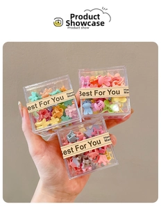 Tre scatole di mini mollette colorate per capelli a forma di fiori e coniglietti
