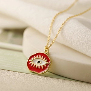 Gold chain necklace with a red enamel evil eye pendant and micro-inlaid zircon accents