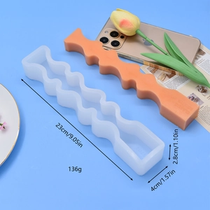Irregular wavy candle silicone mold with finished orange classic scented wax candle
