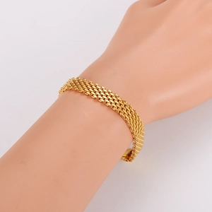 Fashionable gold layered braided wide chain bracelet for women on display arm