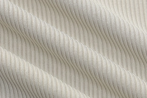 Macro shot of beige and white striped ribbed fabric showing fine texture and softness