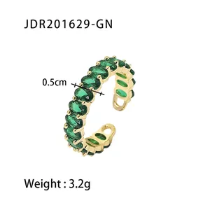 Detail of 0.5cm wide gold stainless steel ring with green zircon stones, weighing 3.2g