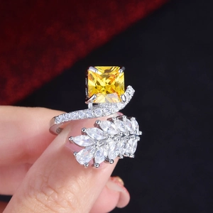 Macro shot of radiant cut yellow diamond ring with marquise-shaped side stones