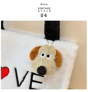Detail of plush tote bag with LOVE heart embroidery and a cute cartoon dog keychain charm