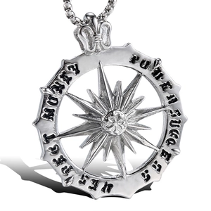 Macro shot of silver sunburst pendant with Gothic engraved letters and box chain